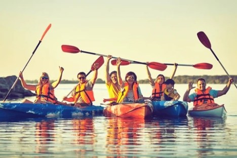 a group of people riding on the back of a boat